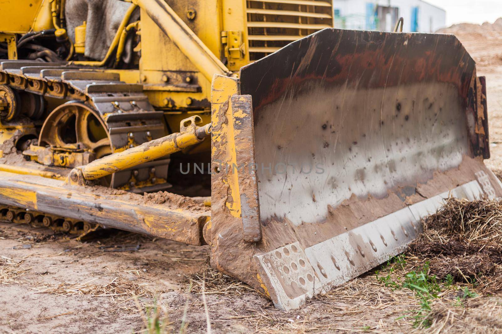 Grader tractor on caterpillars of yellow color