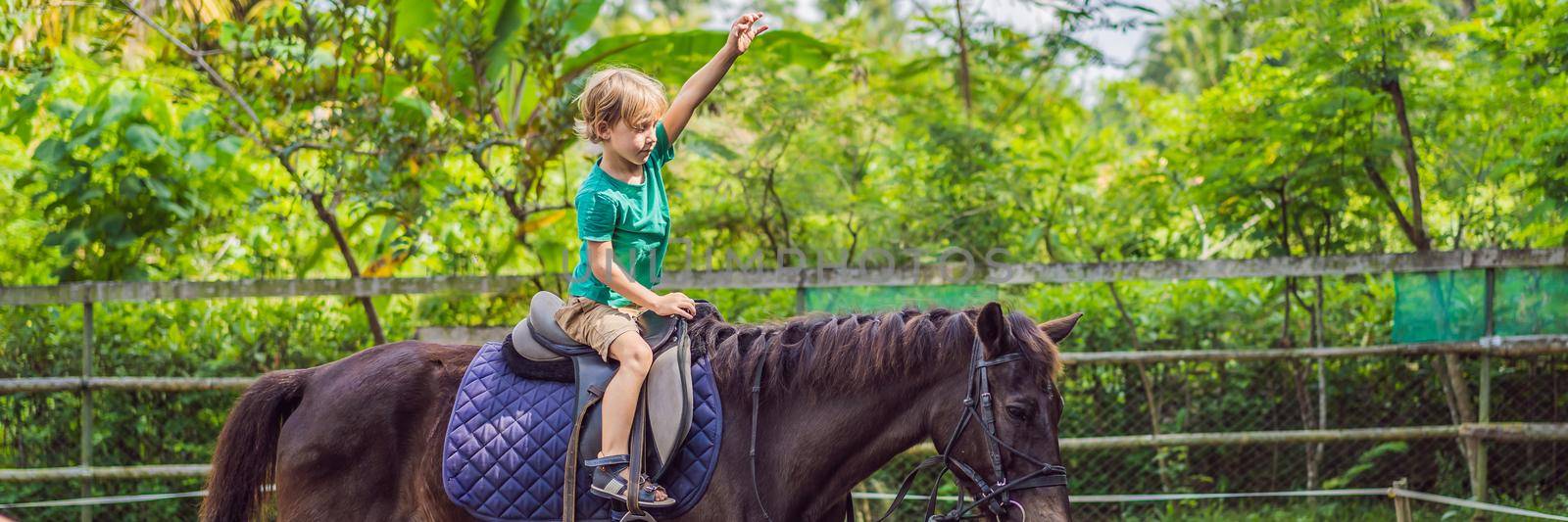 Boy horseback riding, performing exercises on horseback BANNER, LONG FORMAT by galitskaya