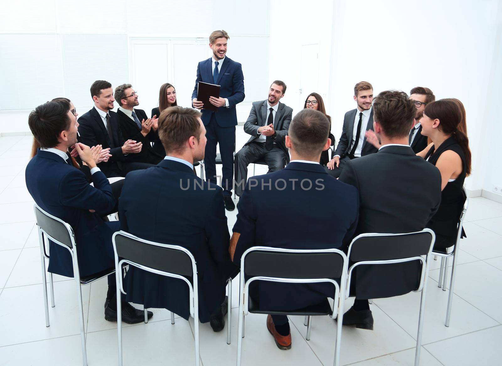 business people applauding the coach after the lecture . business concept