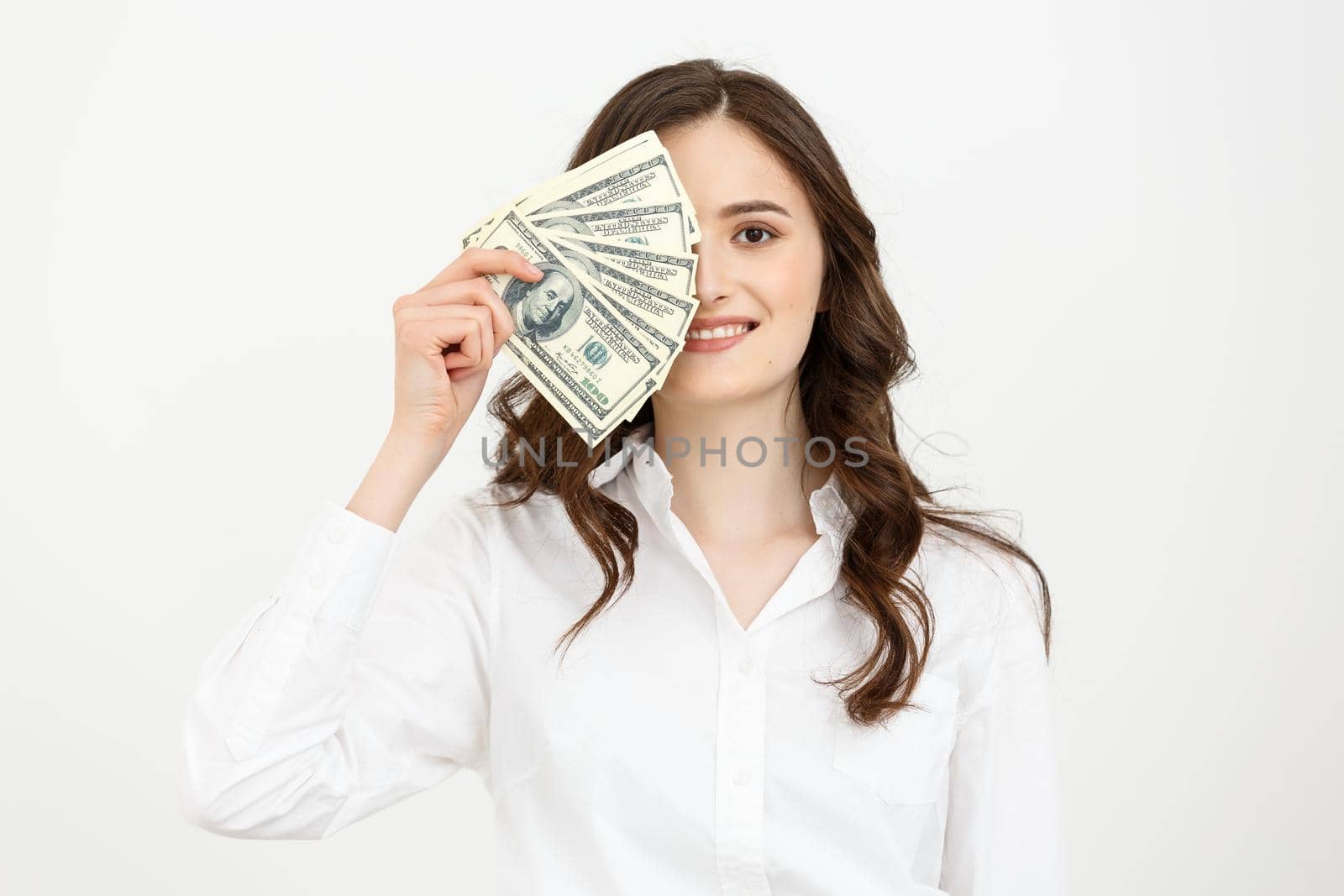 Young happy business woman with dollars in hand. Isolated on white background. by Benzoix