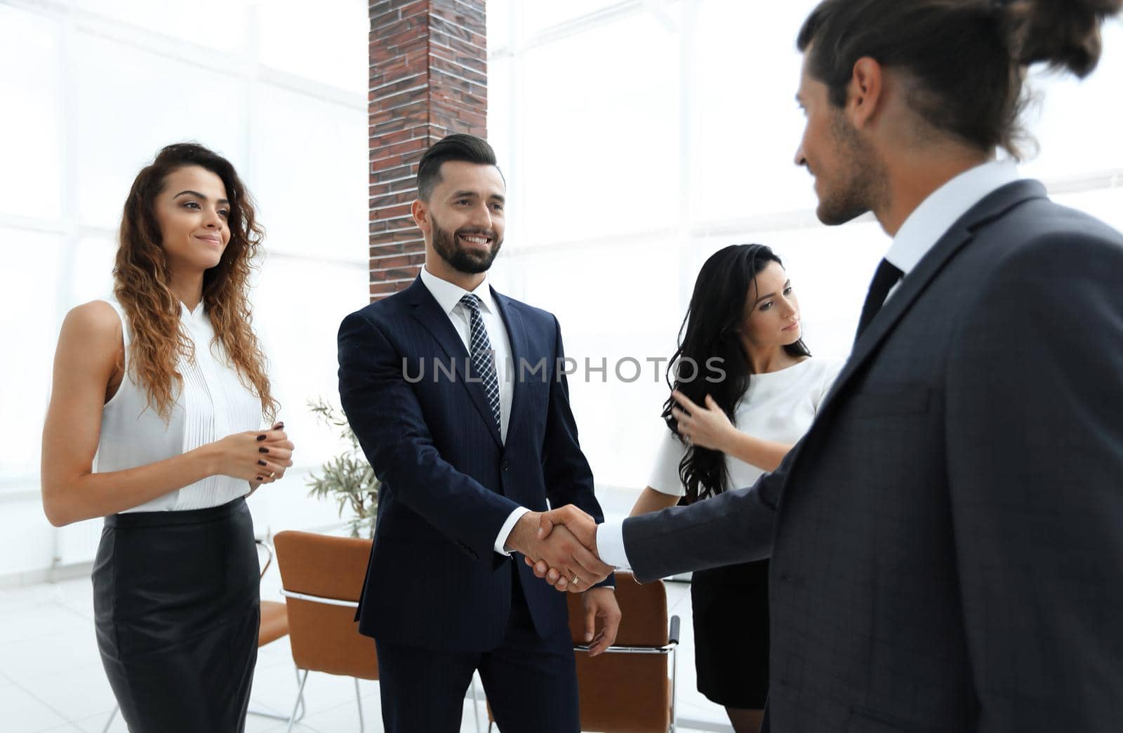 handshake of business people on the background of the office.business concept.