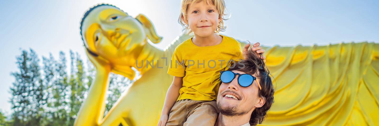 Happy tourists dad and son on background ofLying Buddha statue. BANNER, LONG FORMAT