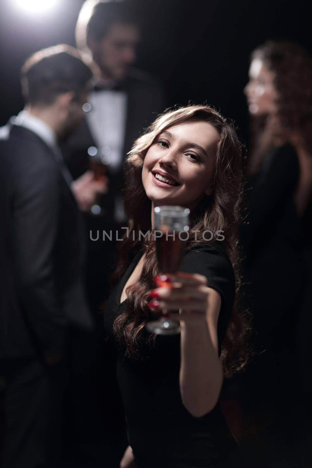 happy young woman raising glass in toast by asdf