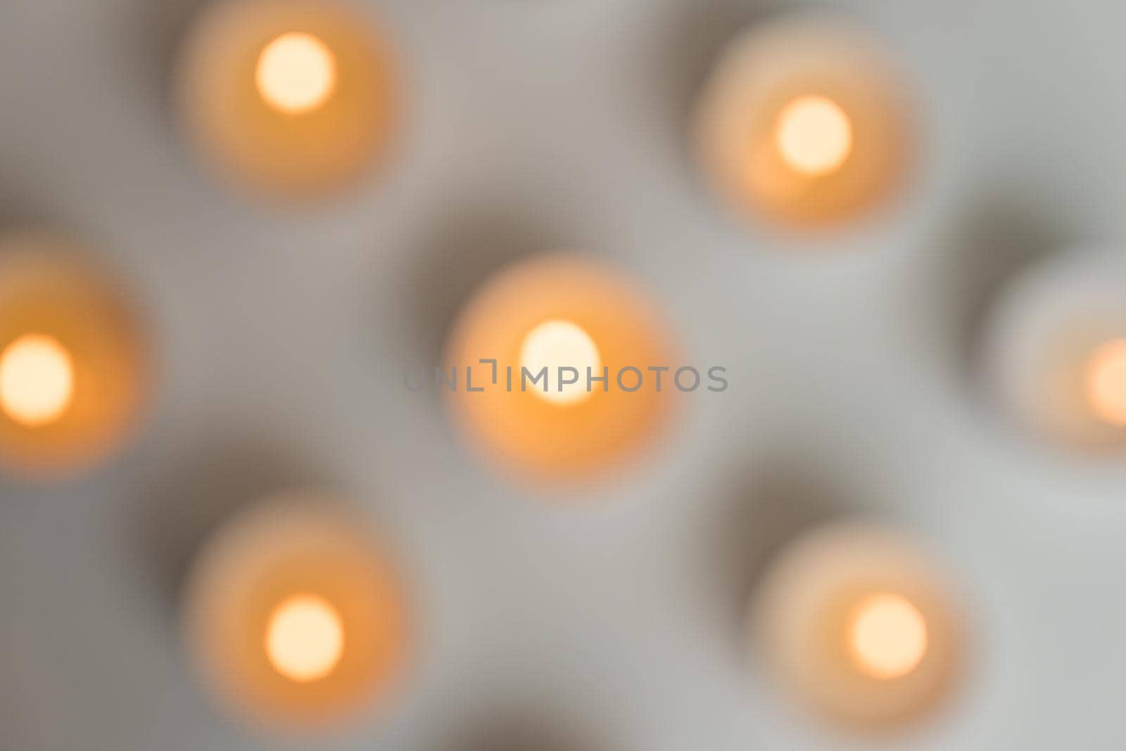 Blurry, abstract, high angle view of tealights on table