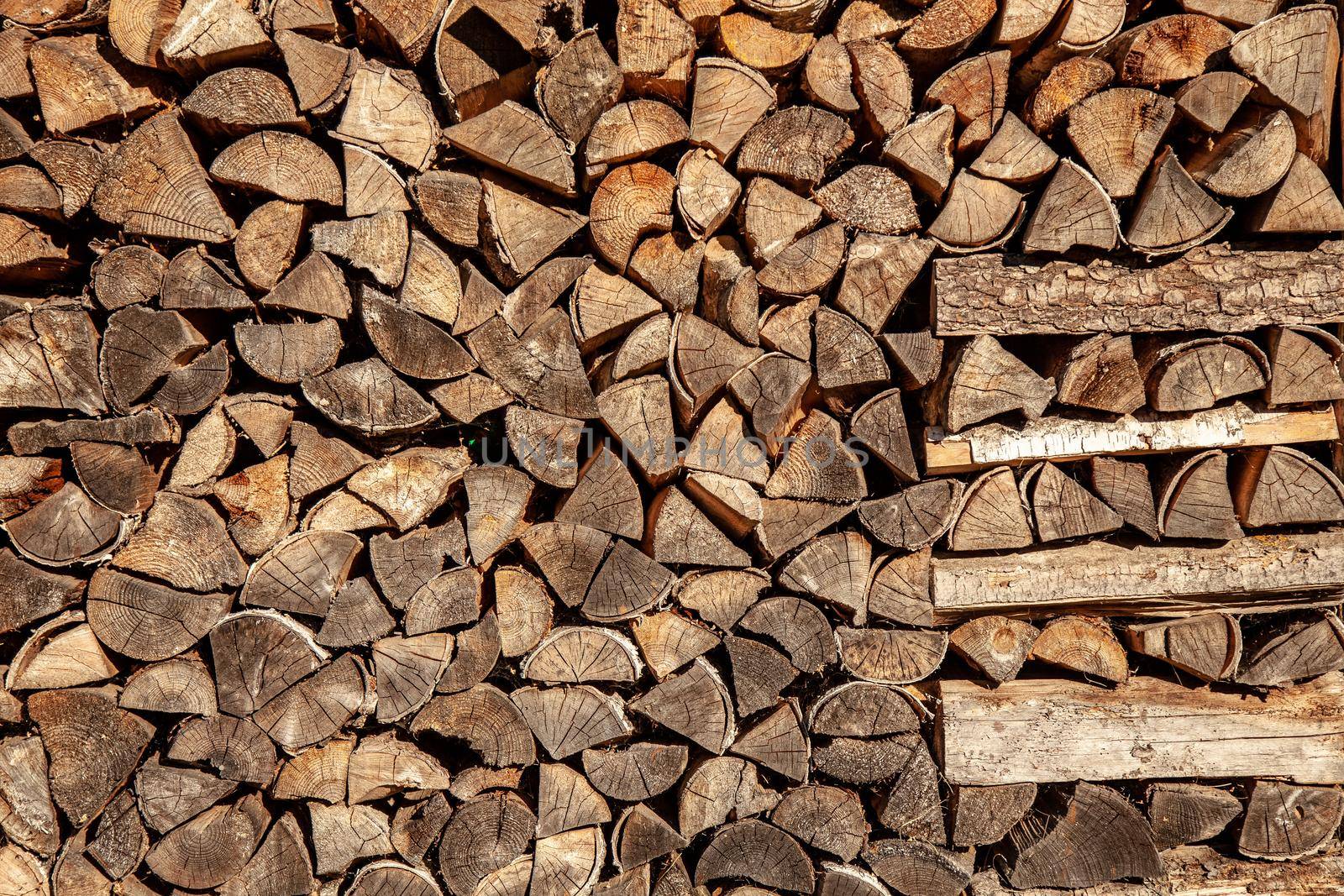 wall firewood , Background of dry chopped firewood logs in a pile.
