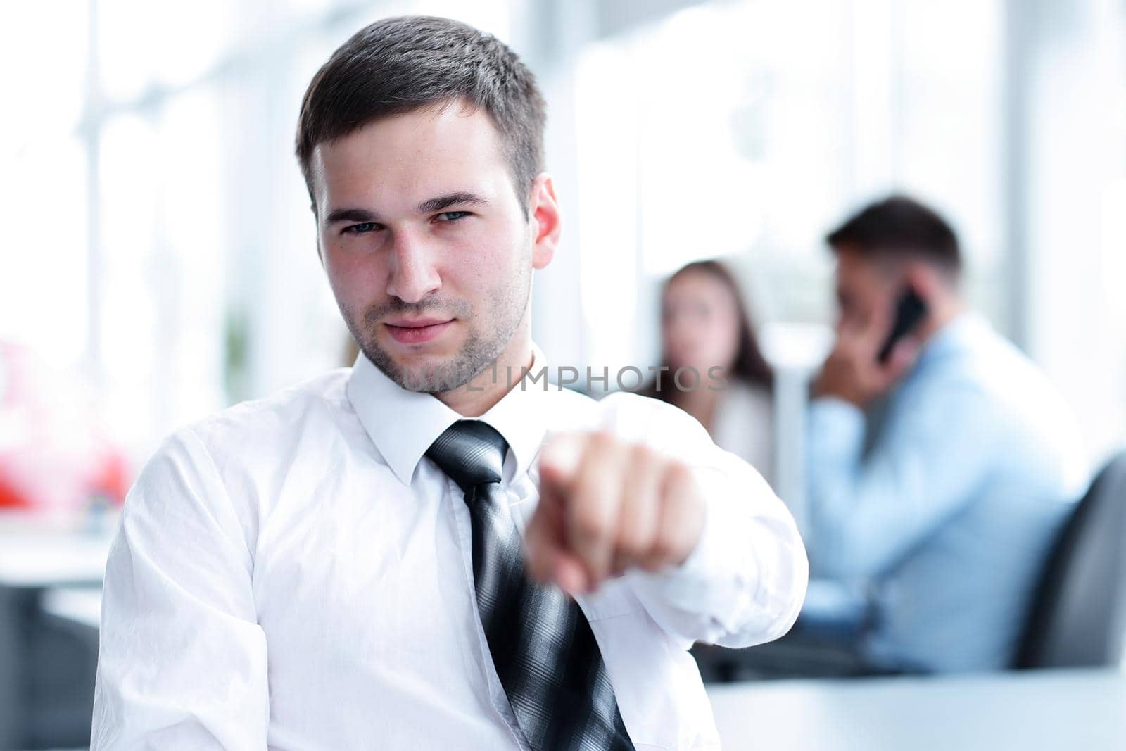 concept of perspective.confident businessman pointing forward. photo on the background of office