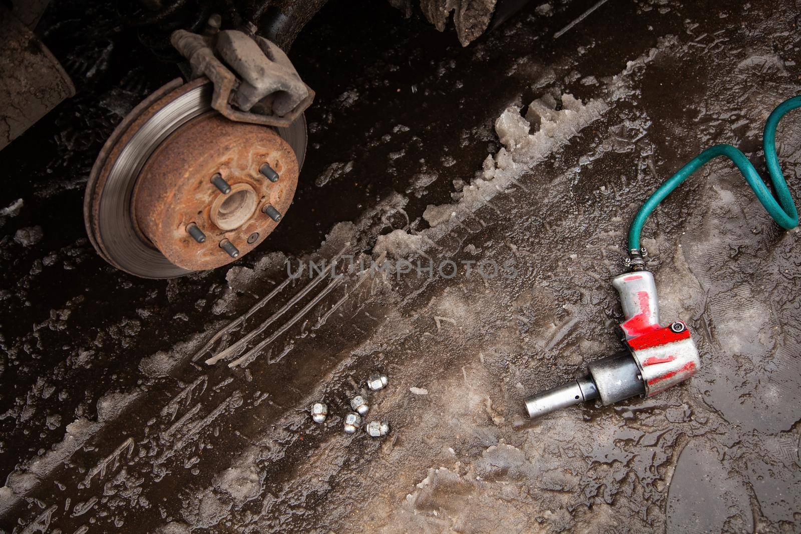 a car without a wheel, a bolt loosening gun wheel bolt