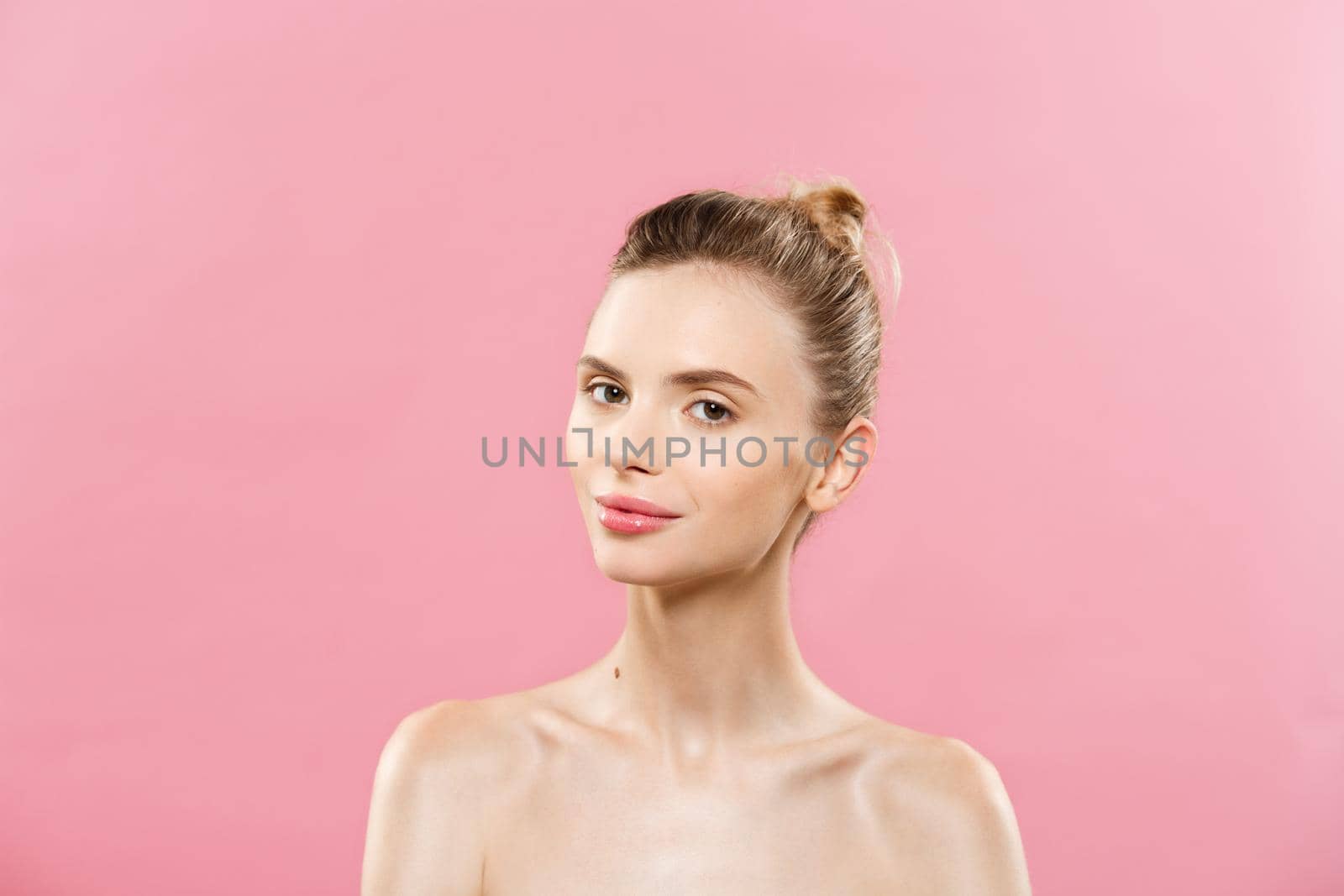 Skin Care Concept - Charming young caucasian woman with perfect makeup photo composition of brunette girl. Isolated on pink background with Copy Space