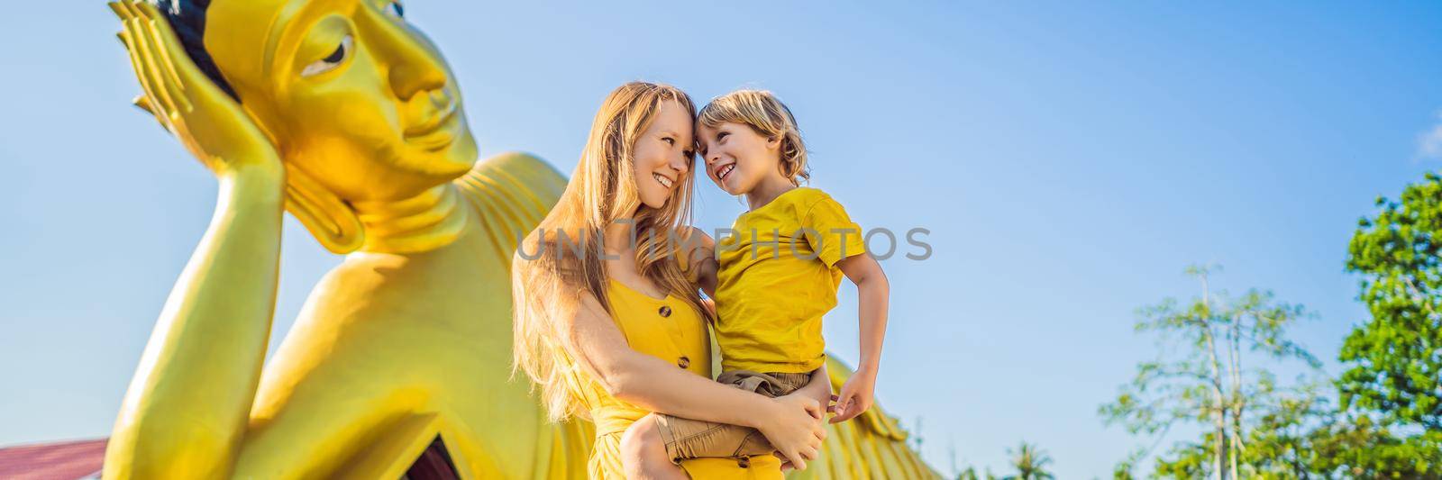 Happy tourists mother and son on background ofLying Buddha statue BANNER, LONG FORMAT by galitskaya