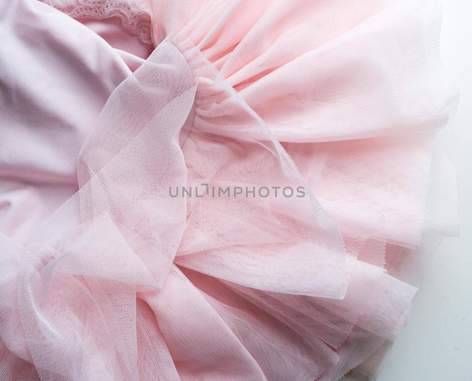 High angle close up view of little girl's pink tutu on white table by natalie_board