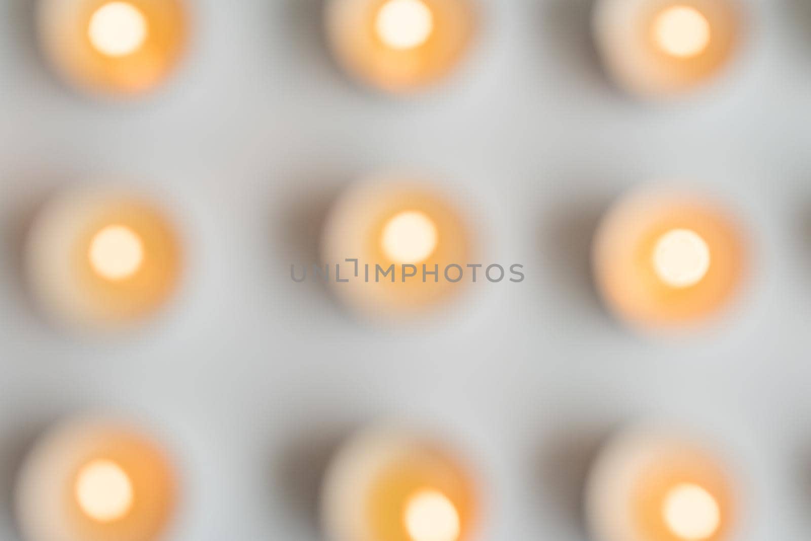 Blurry, abstract, high angle view of tealights on table