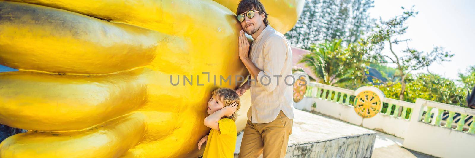 Happy tourists dad and son on background ofLying Buddha statue BANNER, LONG FORMAT by galitskaya
