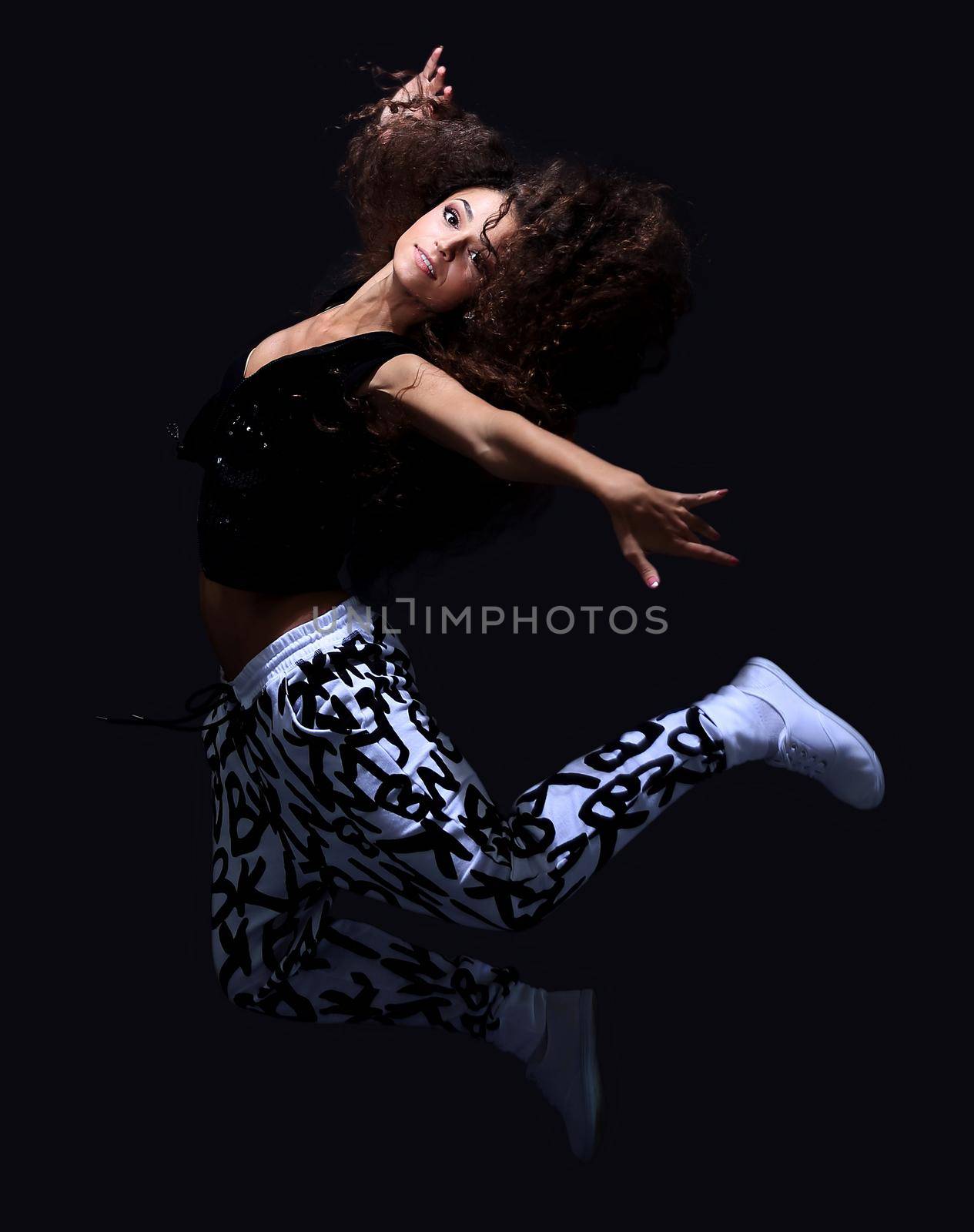 young woman hip hop dancer with grunge wall background texture