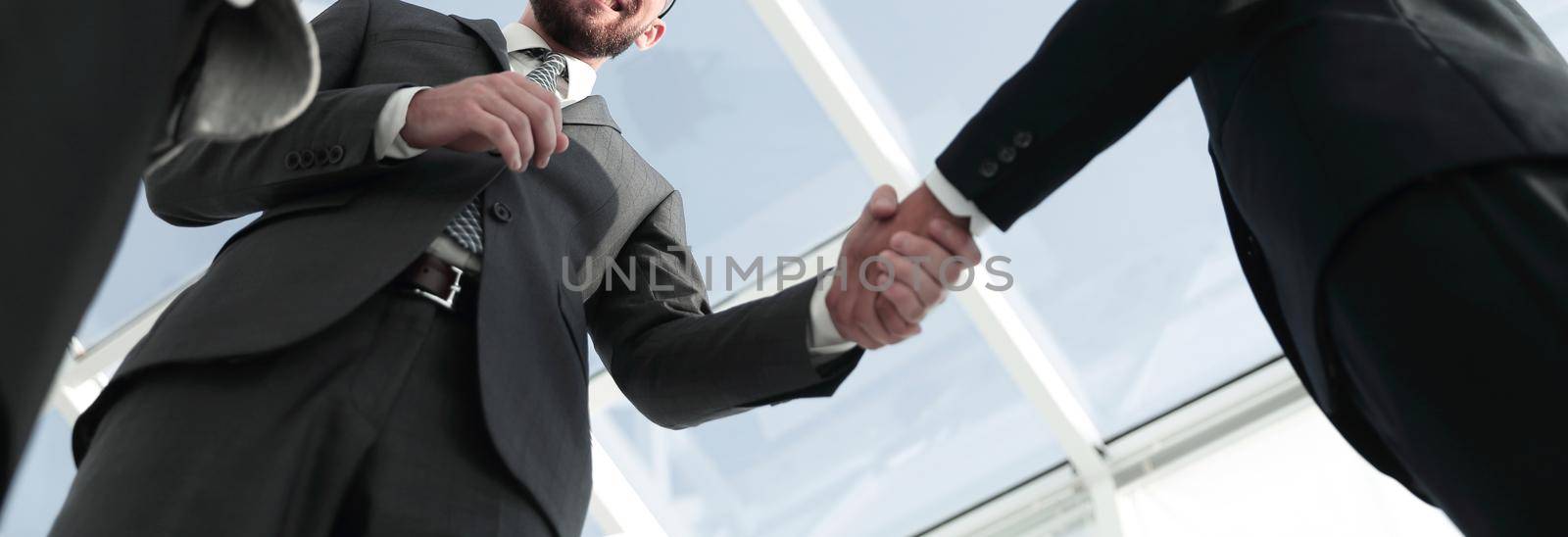 Image of a firm handshake standing for a trusted partnership