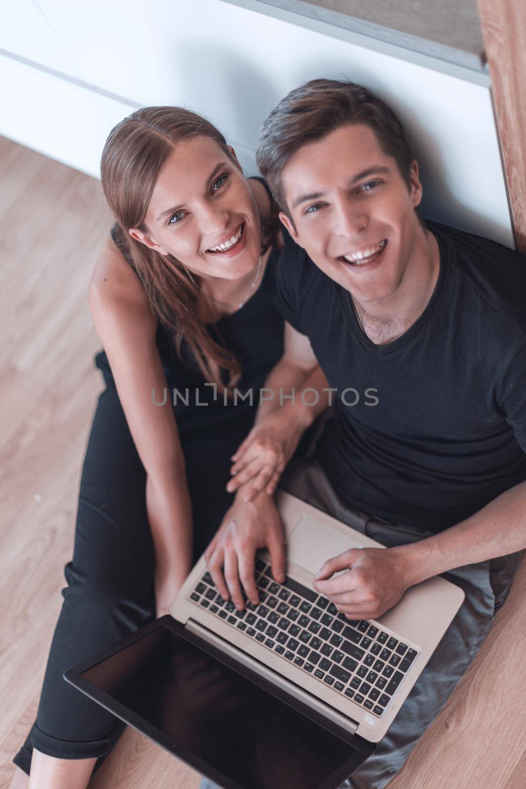 close up. young couple with laptop looking at camera . people and technology