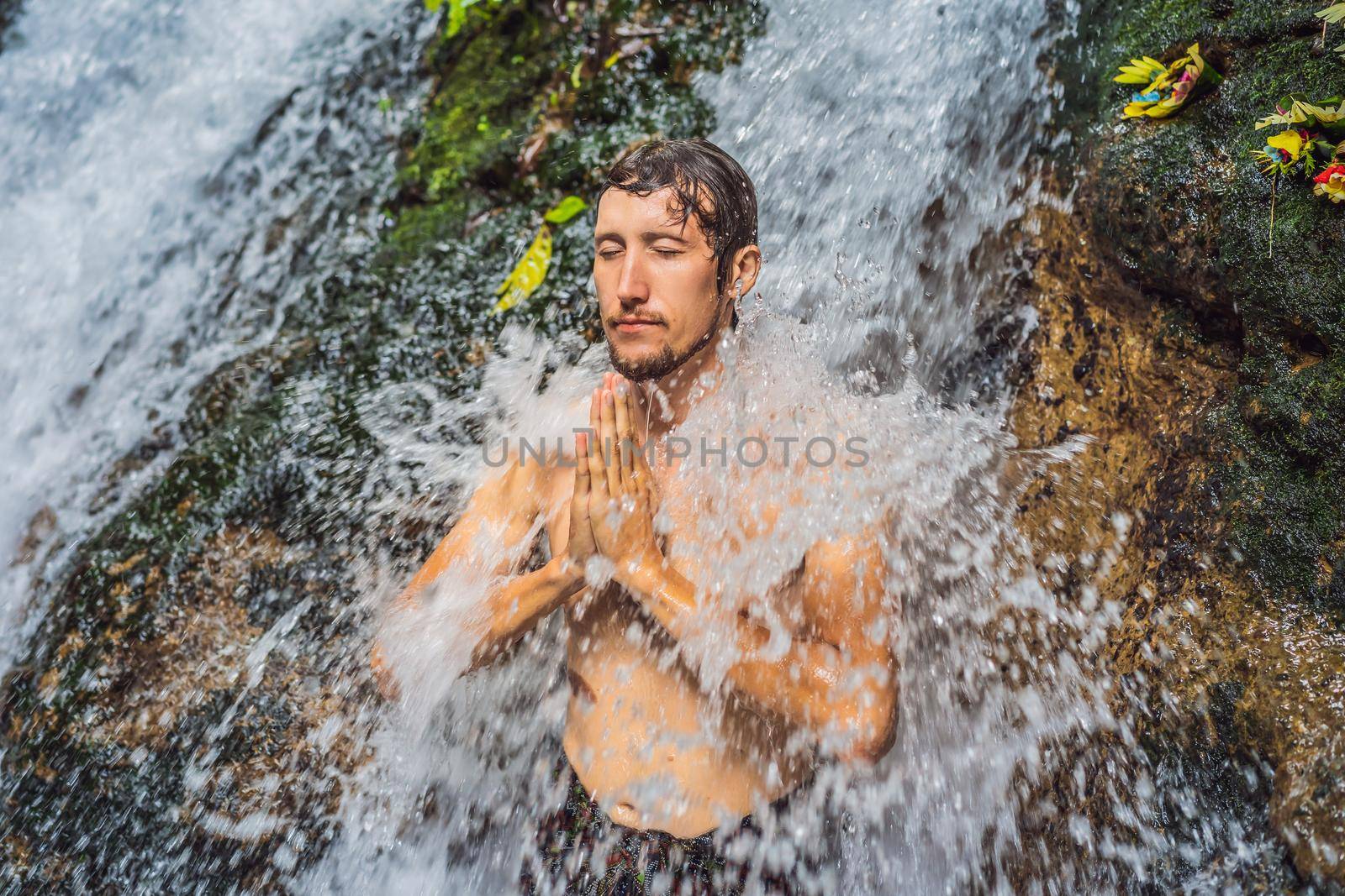 Young man tourist in Holy springs Sebatu in Bali.