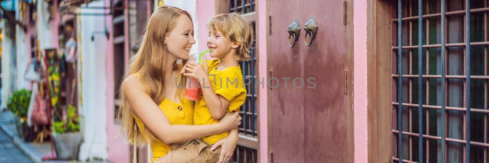 BANNER, LONG FORMAT Mom and son tourists on the Street in the Portugese style Romani in Phuket Town. Also called Chinatown or the old town. Traveling with kids concept by galitskaya