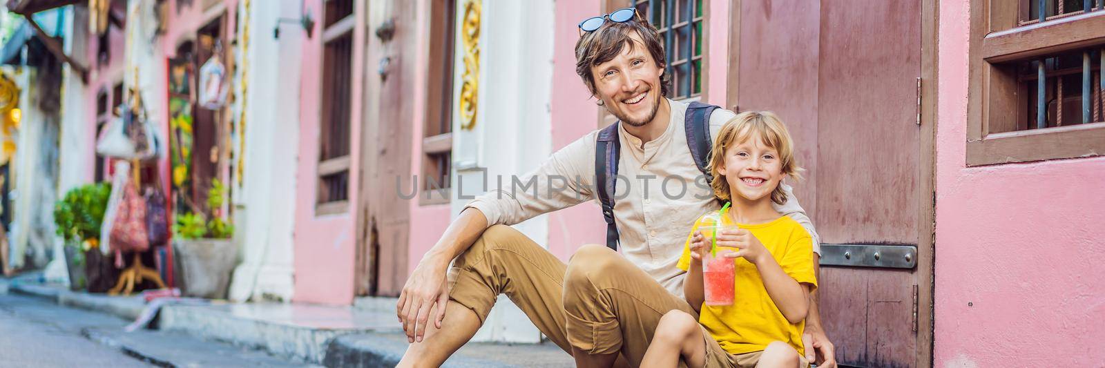 BANNER, LONG FORMAT Dad and son tourists on the Street in the Portugese style Romani in Phuket Town. Also called Chinatown or the old town. Traveling with kids concept by galitskaya