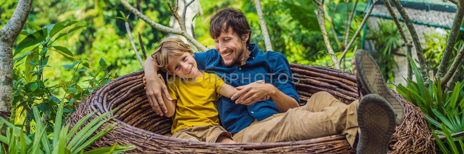 BANNER, LONG FORMAT Bali trend, straw nests everywhere. Child friendly place. Happy family enjoying their travel around Bali island, Indonesia. Making a stop on a beautiful hill. Photo in a straw nest, natural environment. Lifestyle. Traveling with kids concept. What to do with children by galitskaya