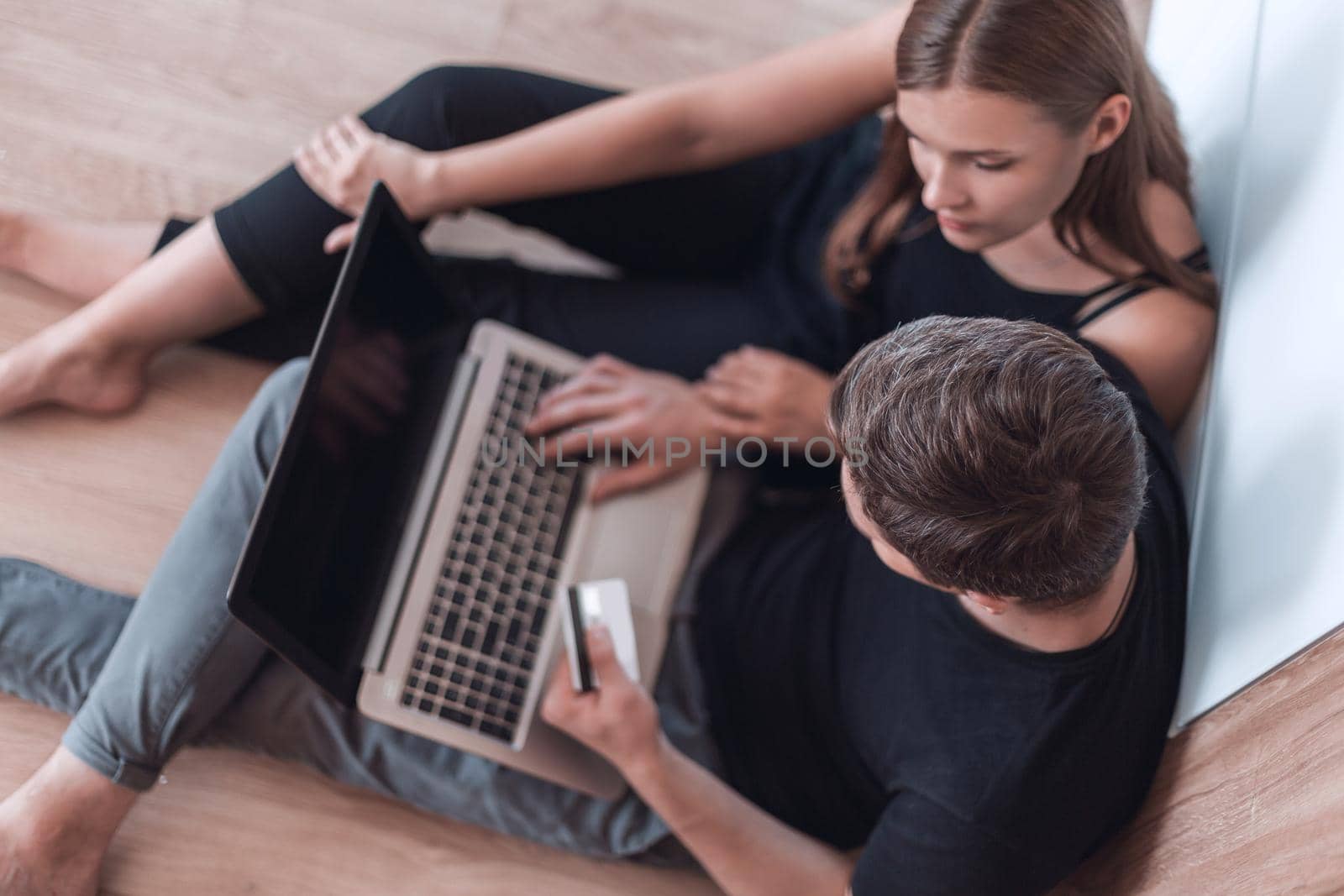 close up. a young family uses a laptop for online shopping by asdf