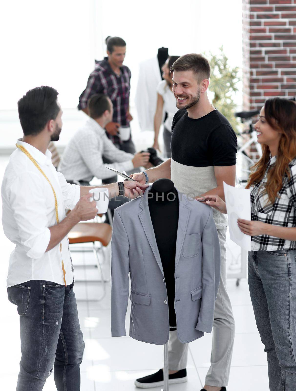 group of designers discuss men's suit by asdf