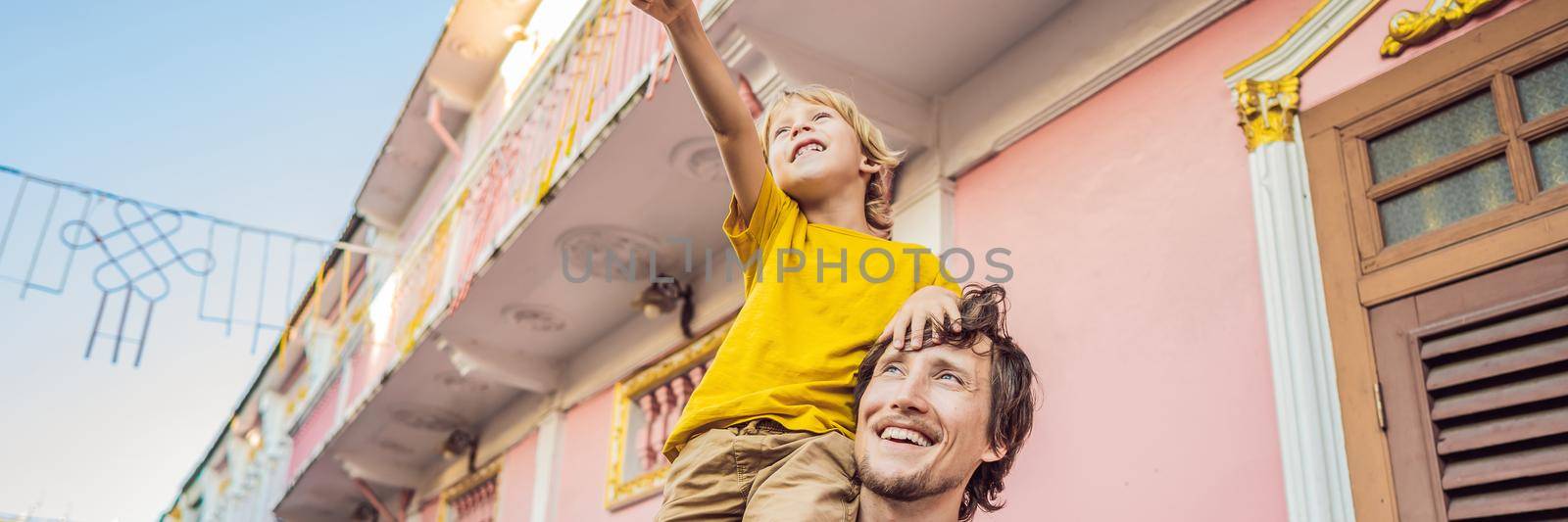BANNER, LONG FORMAT Dad and son tourists on the Street in the Portugese style Romani in Phuket Town. Also called Chinatown or the old town. Traveling with kids concept by galitskaya