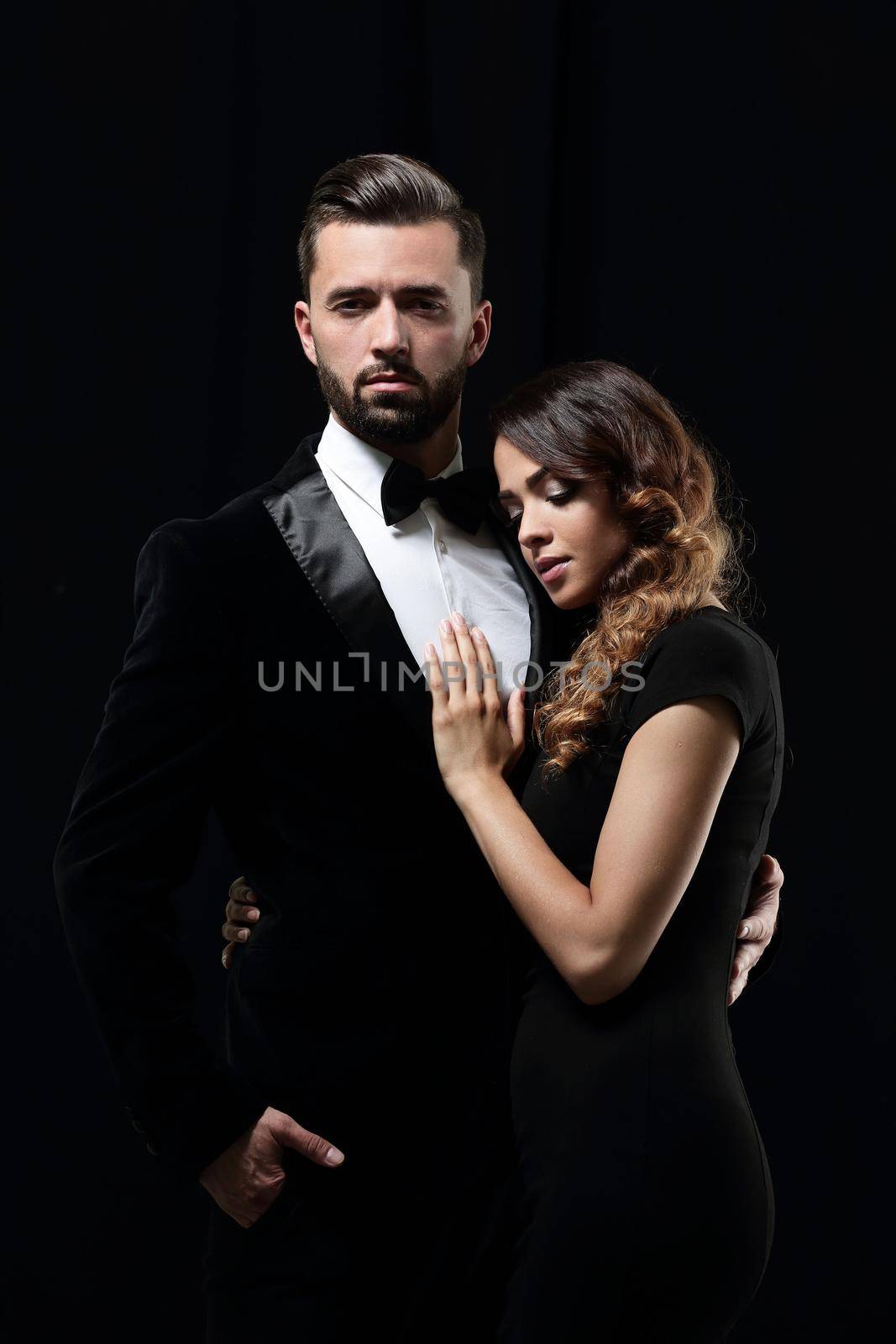 portrait of fashion couple on black background by asdf