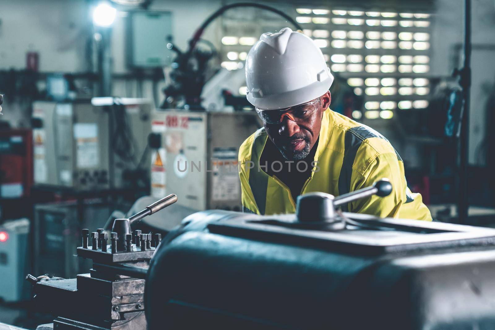 Factory worker or engineer do machine job in adept manufacturing workshop . Industrial people and manufacturing labor concept .