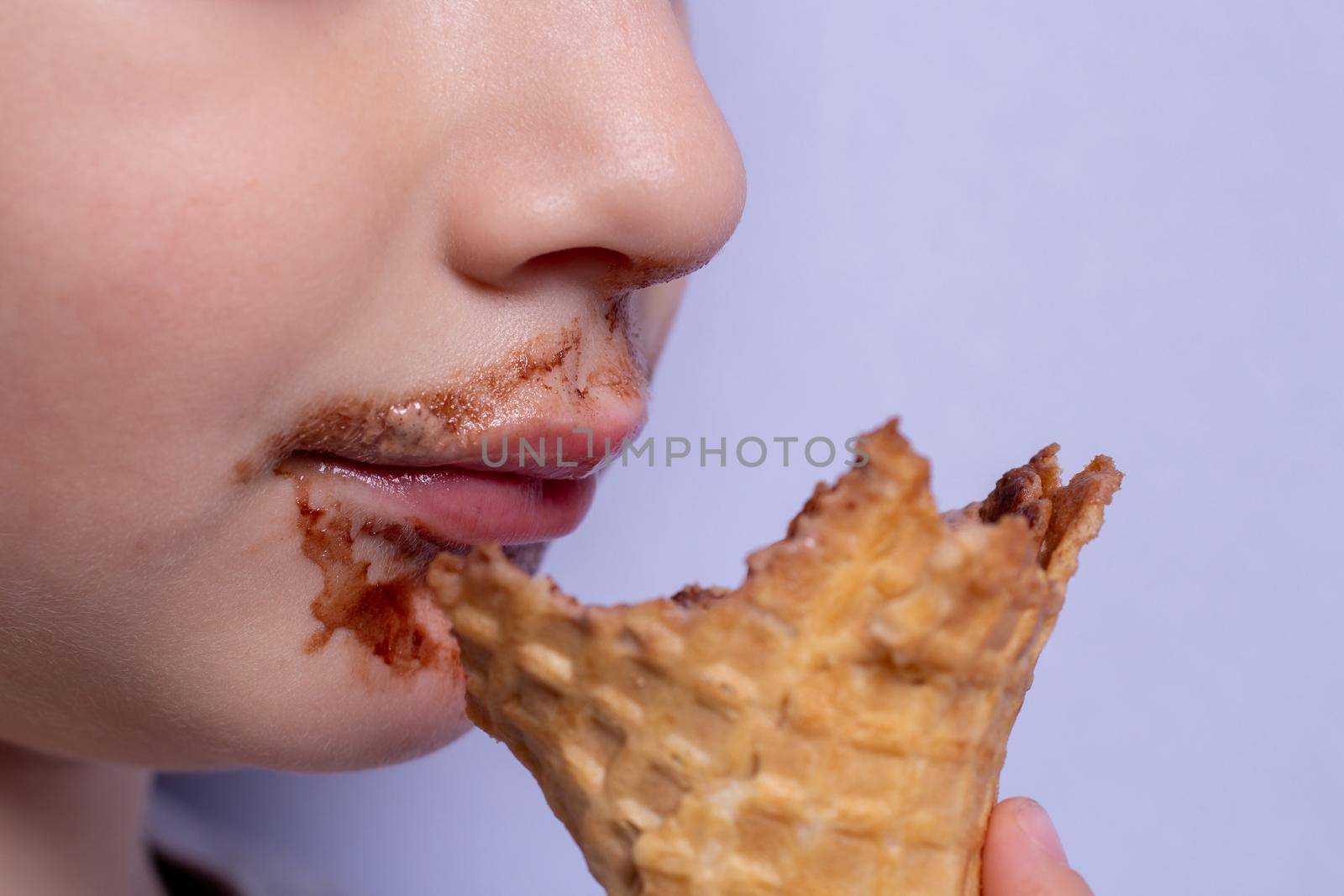 image of a boy sitting chocolate ice cream, smeared mouth