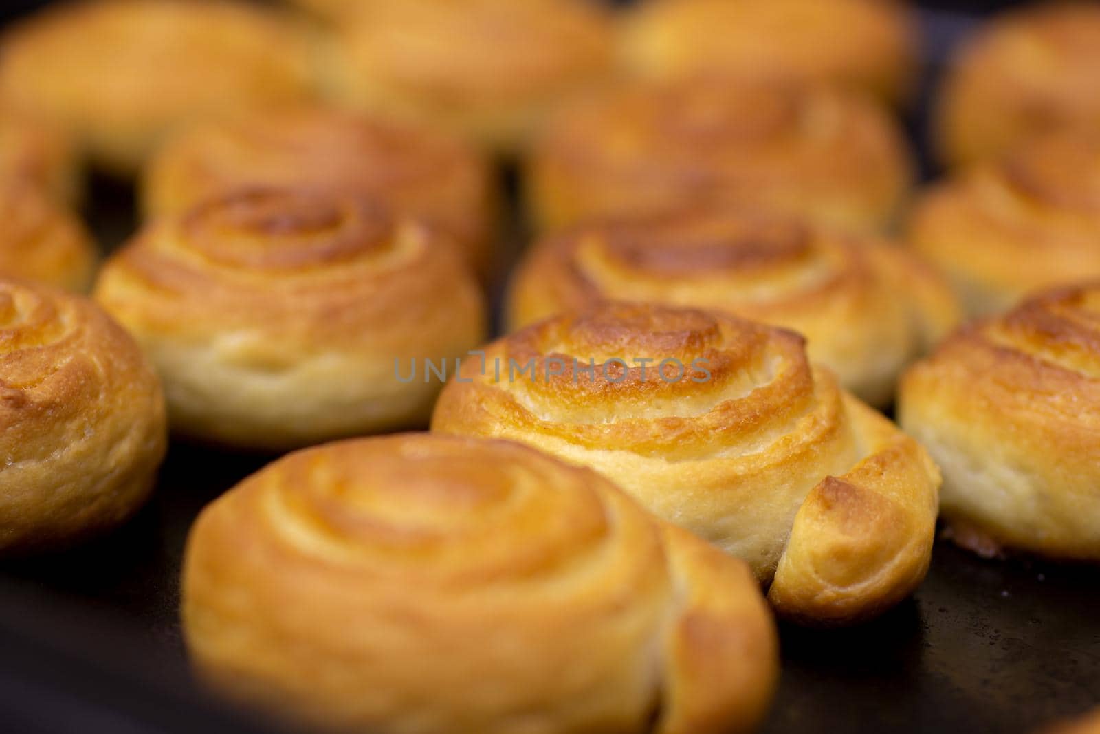 baking sweet buns in the oven close-up. the selected focus. by bySergPo