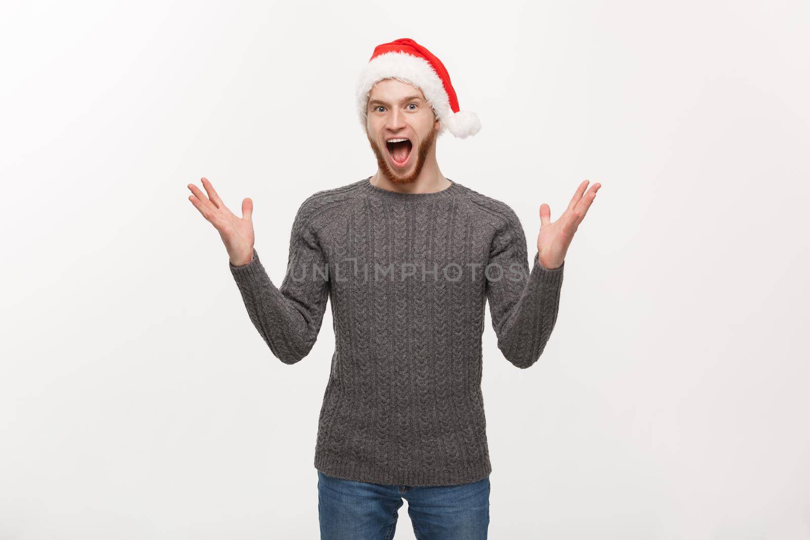 Holiday Concept - Young beard man in sweater showing hand up with exciting feeling.