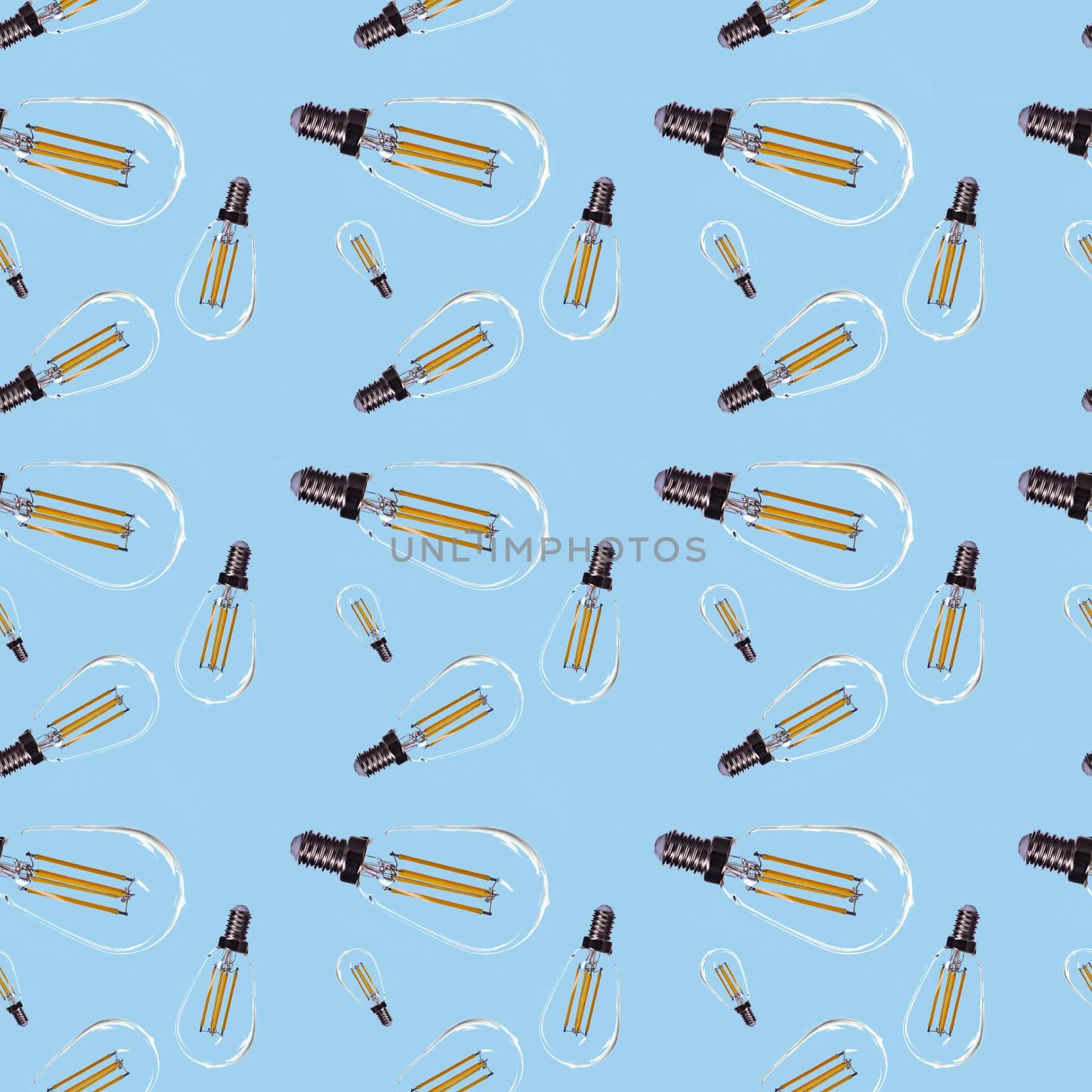 Seamless pattern in the form of electric lamps of different sizes on a blue background.