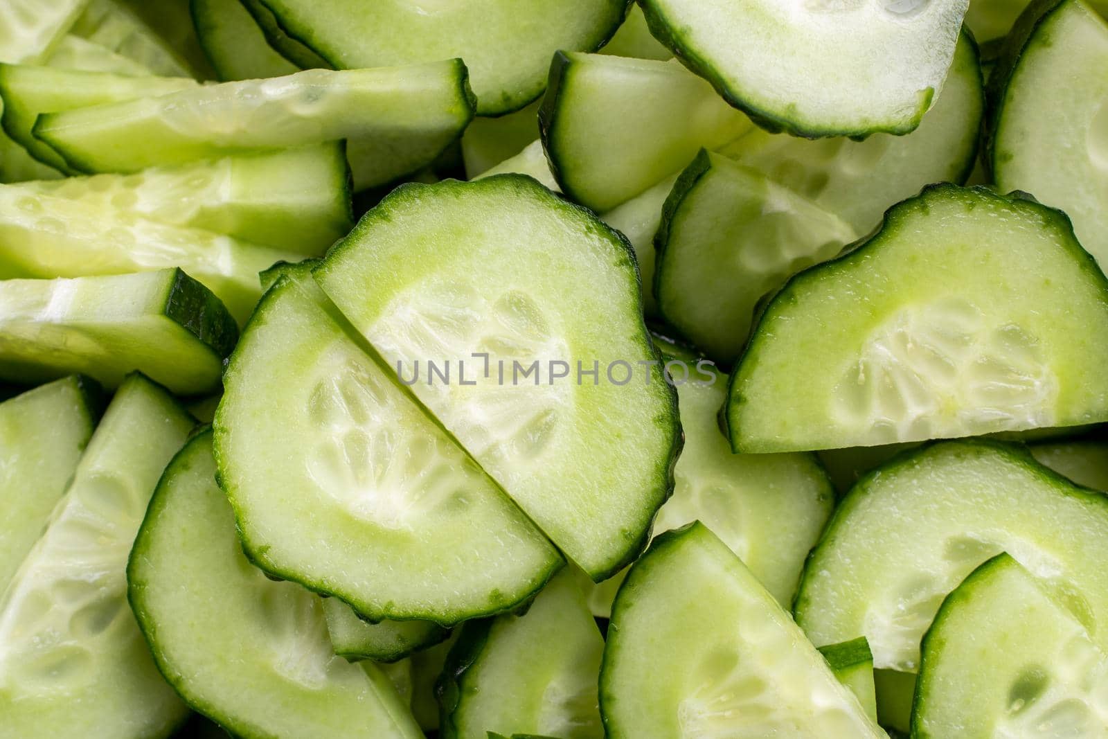 an ingredient for a salad. close-up of cucumber slices, background of sliced cucumber. Macro-type of vegetable. Food background.