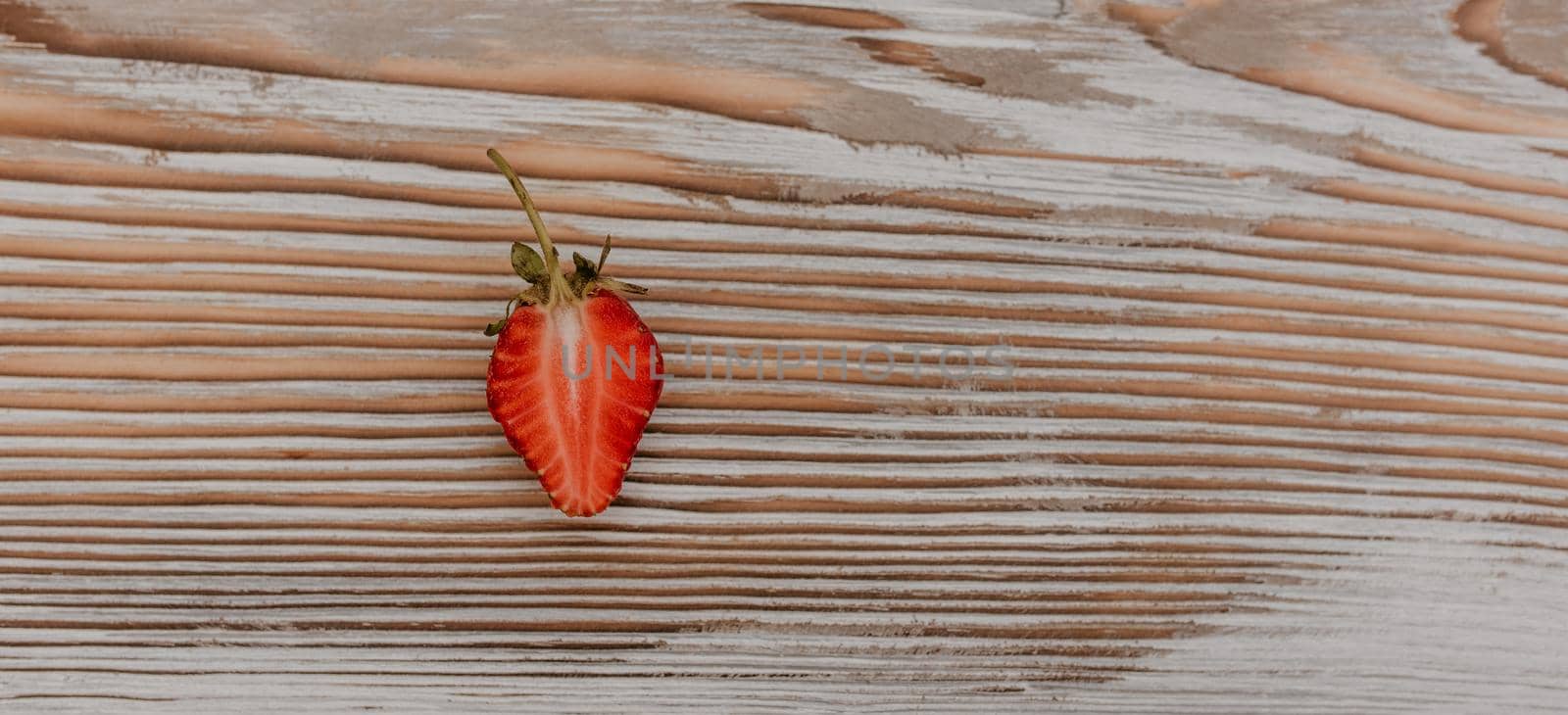 scattered juicy fresh red strawberries on the table with vintage plank. mint leaf. drops and splashes of spilled milk. vegetable cutting board. High quality photo