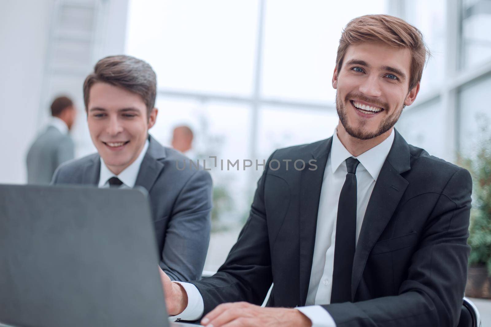 close up. two business men sitting at an office Desk. people and technology