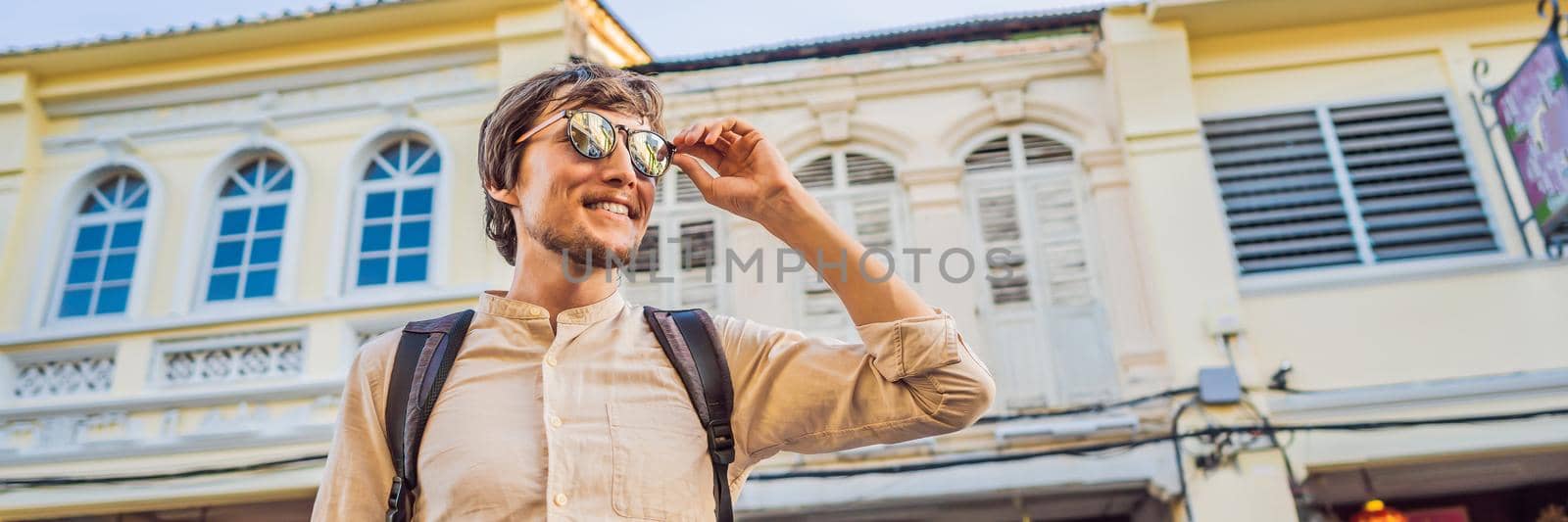 Man tourist on the Street in the Portugese style Romani in Phuket Town. Also called Chinatown or the old town. BANNER, LONG FORMAT