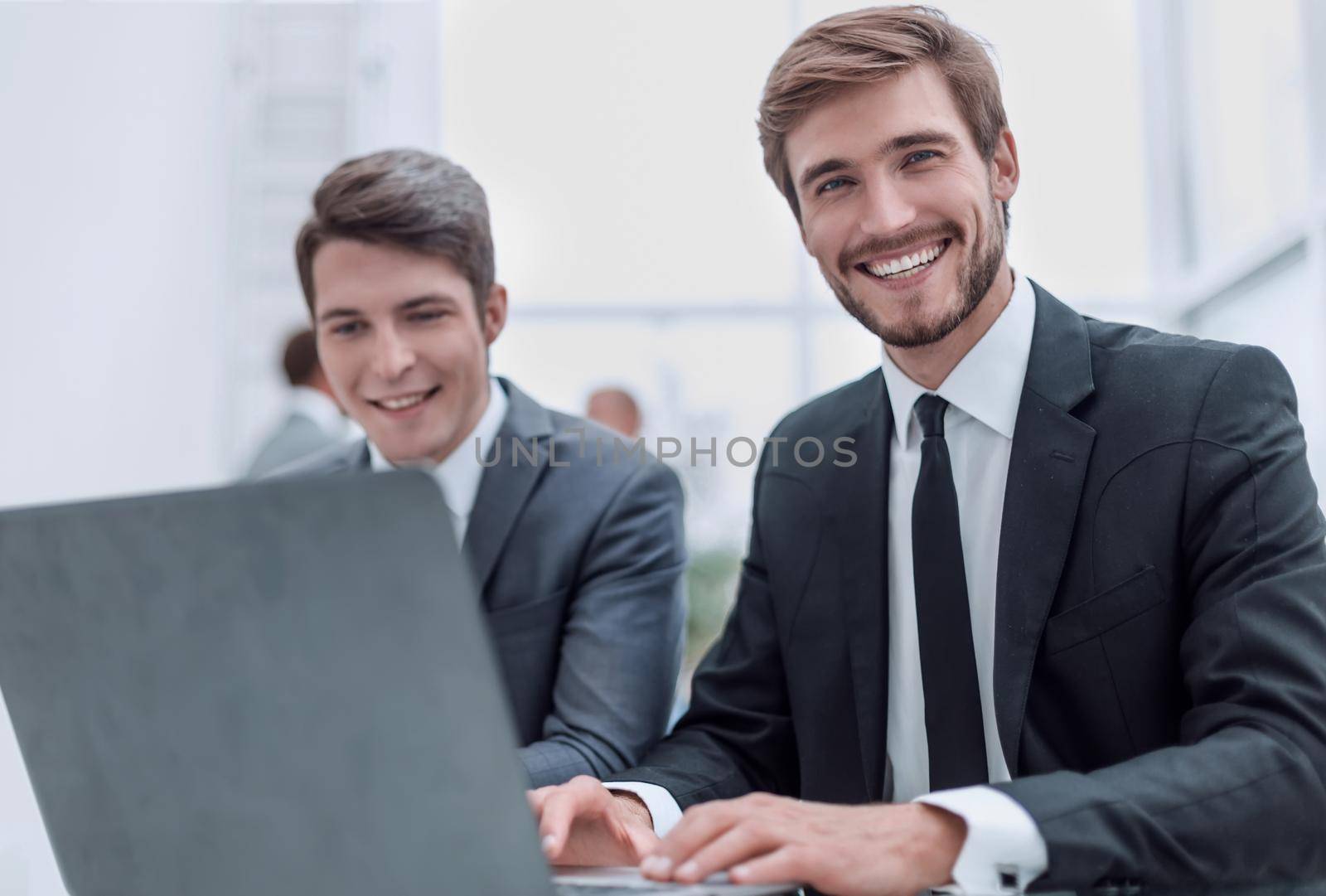 close up. two business men sitting at an office Desk. people and technology