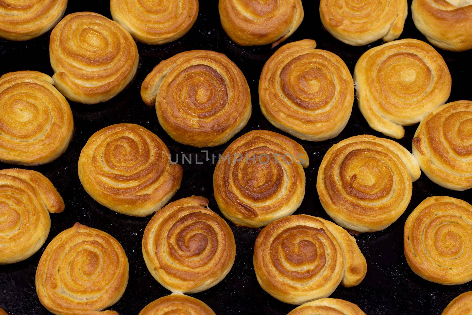 baking sweet buns in the oven close-up. the top view by bySergPo