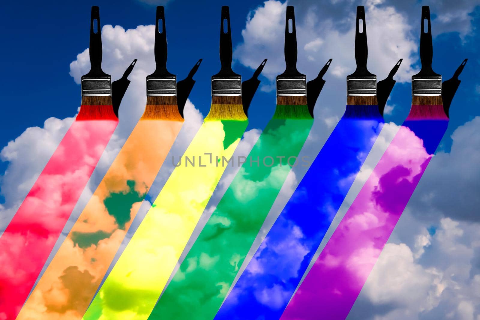 image of several shadow brushes painting rainbow colors in a cloudy blue sky