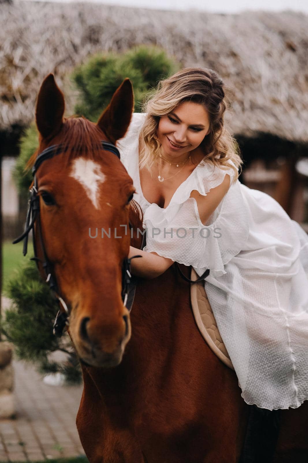 A woman in a white sundress riding a horse near a farm by Lobachad