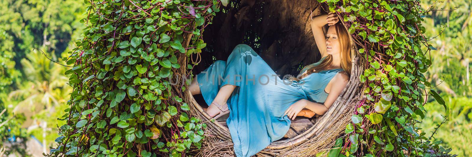 BANNER, LONG FORMAT Bali trend, straw nests everywhere. Young tourist enjoying her travel around Bali island, Indonesia. Making a stop on a beautiful hill. Photo in a straw nest, natural environment. Lifestyle by galitskaya