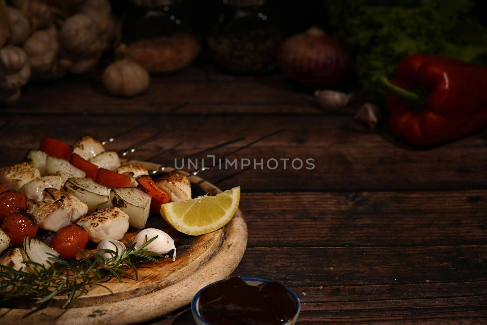 Chicken kebab, BBQ, skewers with cherry tomato, sweet pepper and onions on wooden plate. Barbecue, food, holiday concept.