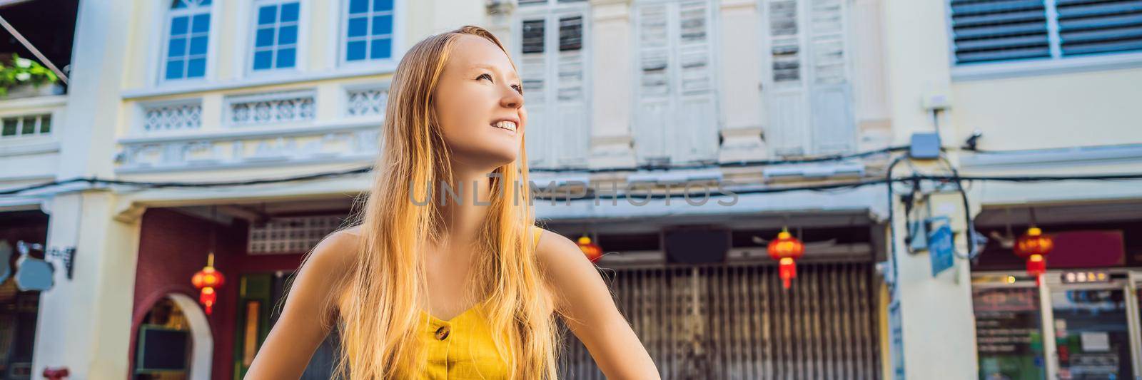 Woman tourist on the Street in the Portugese style Romani in Phuket Town. Also called Chinatown or the old town BANNER, LONG FORMAT by galitskaya