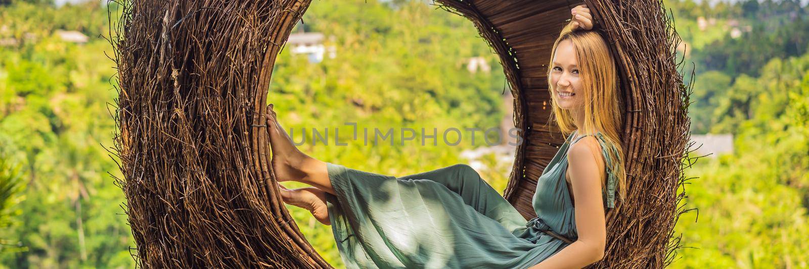 BANNER, LONG FORMAT Bali trend, straw nests everywhere. Young tourist enjoying her travel around Bali island, Indonesia. Making a stop on a beautiful hill. Photo in a straw nest, natural environment. Lifestyle by galitskaya