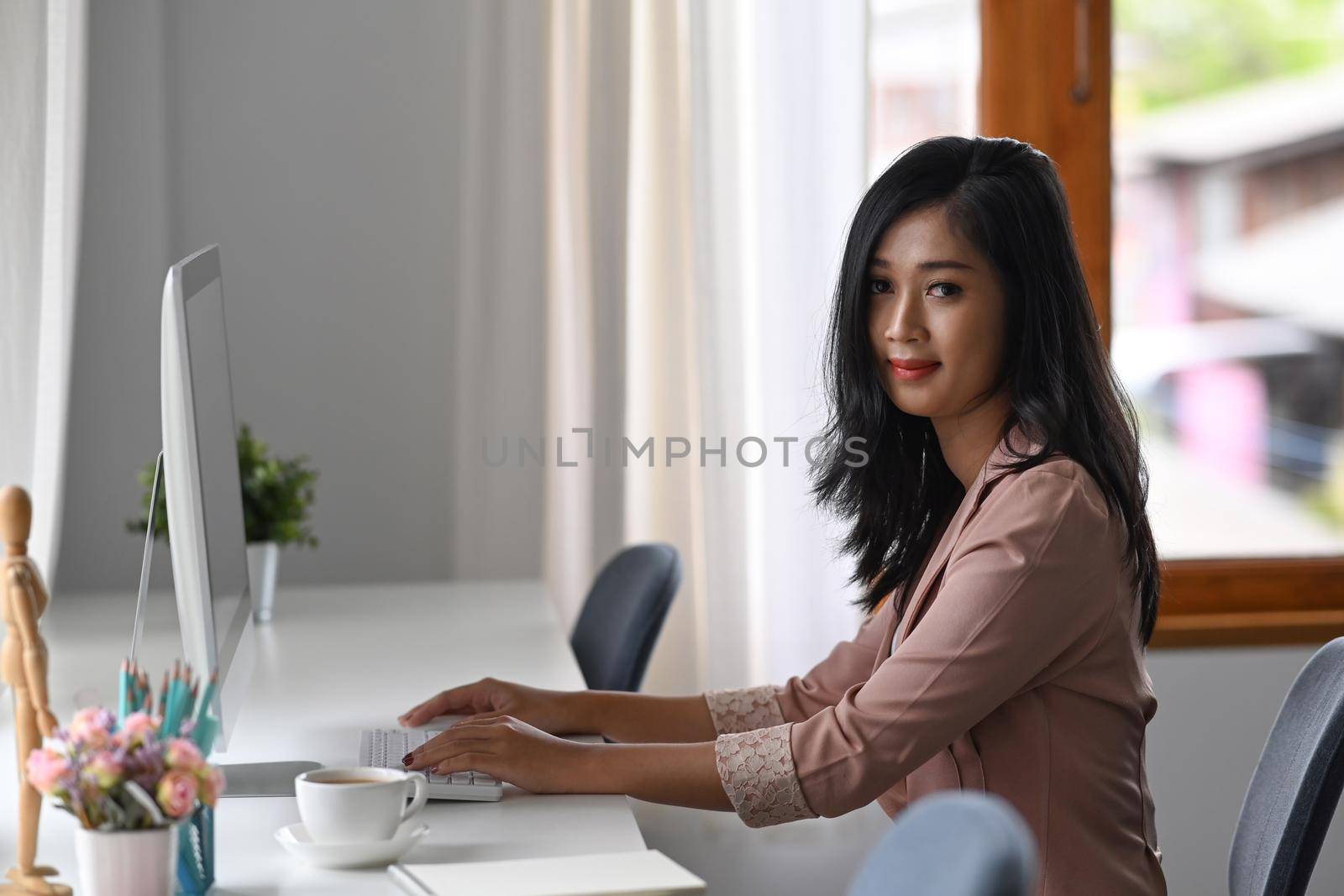 Asian woman office worker working at modern workplace.