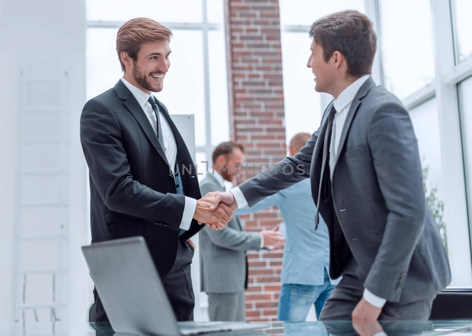 close up. smiling business partners shaking hands. concept of cooperation