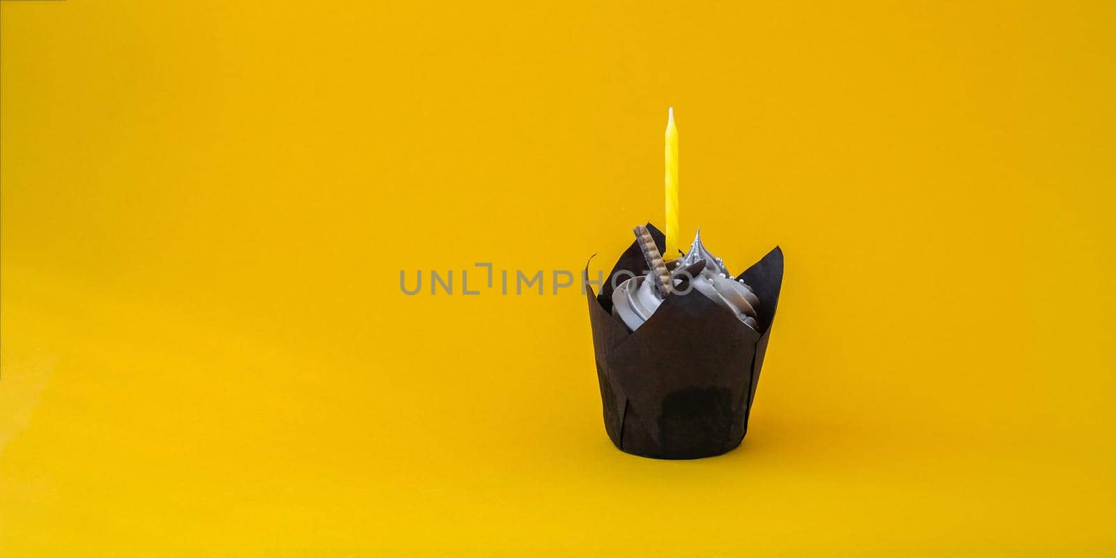Delicious chocolate cupcake with cream and candle on dark background. Chocolate muffin. Birthday cake party. Homemade bakery