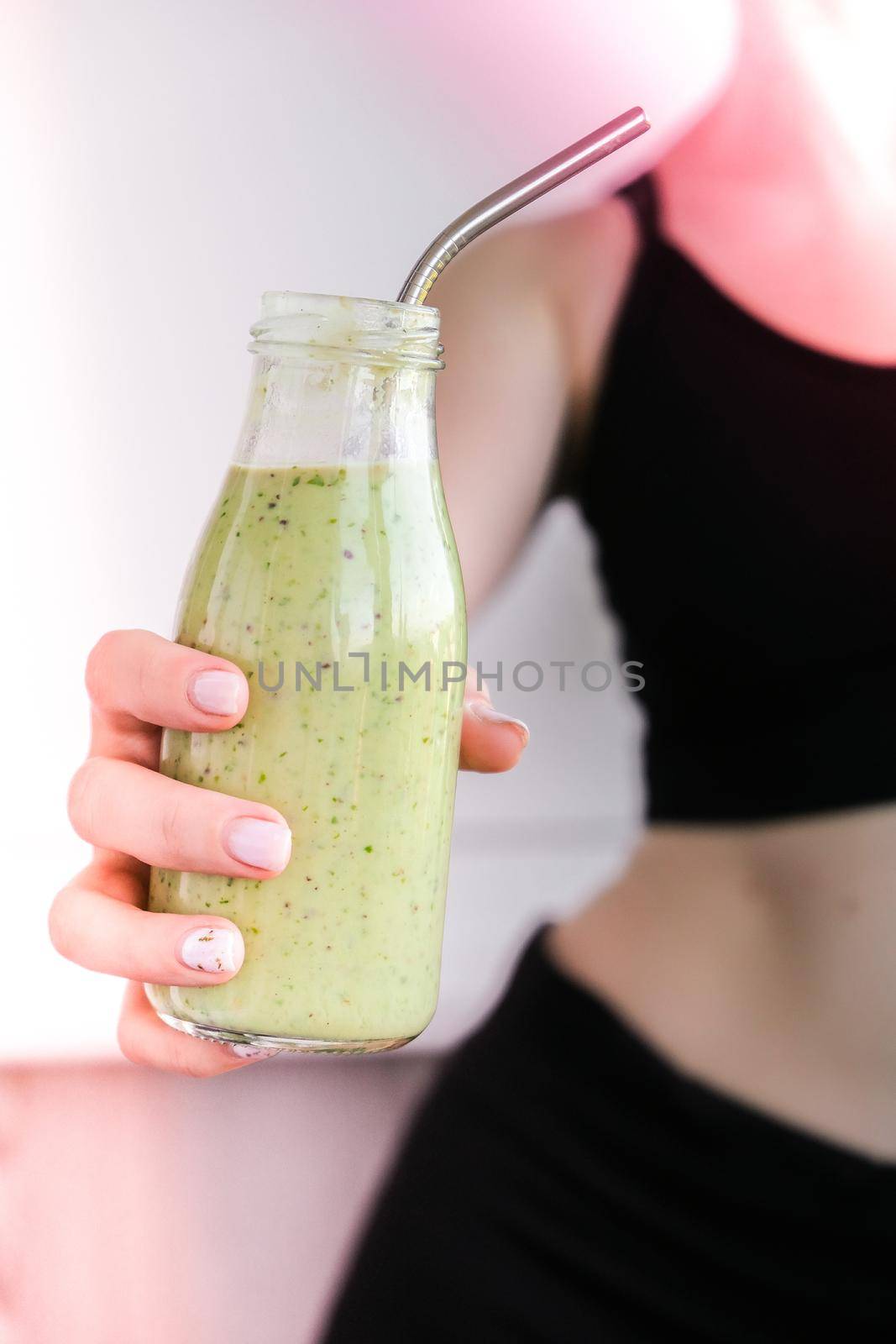 Young millenial blond woman drinking vegan smoothie drink detox. Woman doing yoga exercises at home. Clean eating, weight loss, healthy dieting food concept. Stay healthy. Wellness