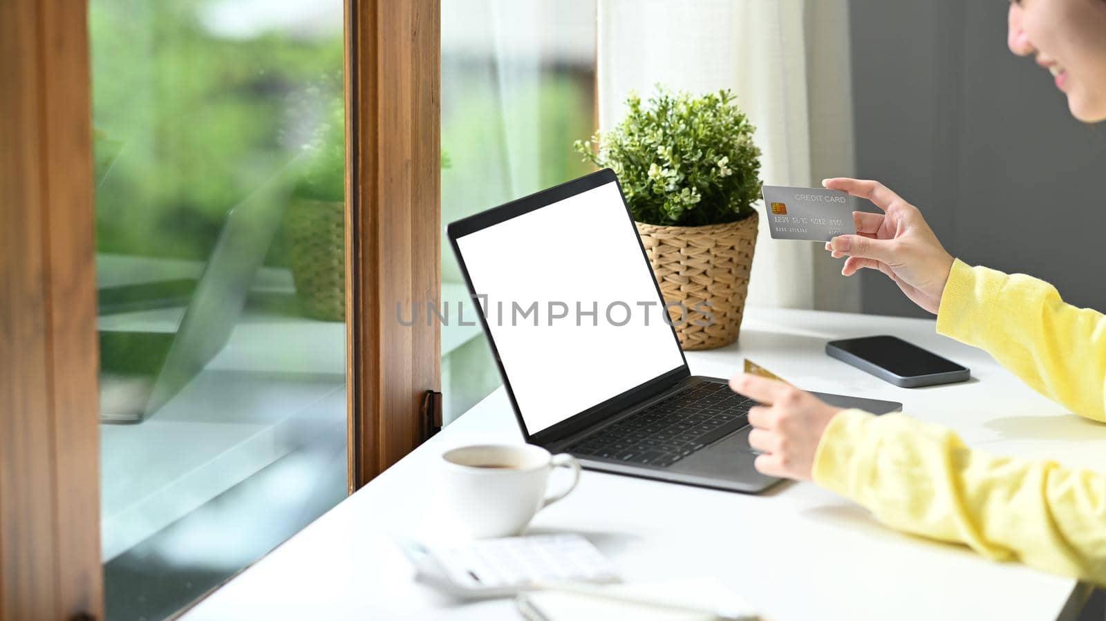 Happy woman holding credit card and using laptop for shopping online, smart payment transaction money transfer technology purchasing product.