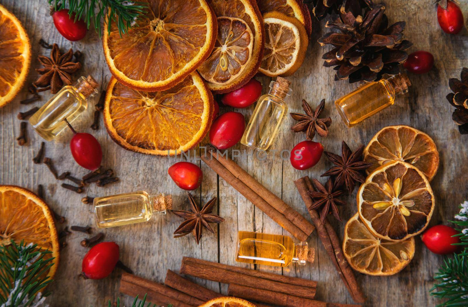 Christmas essential oils in small bottles. Selective focus. Nature.